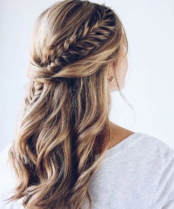 a chic half updo with waves, twists and a fishtail braid going down for a boho bridesmaid
