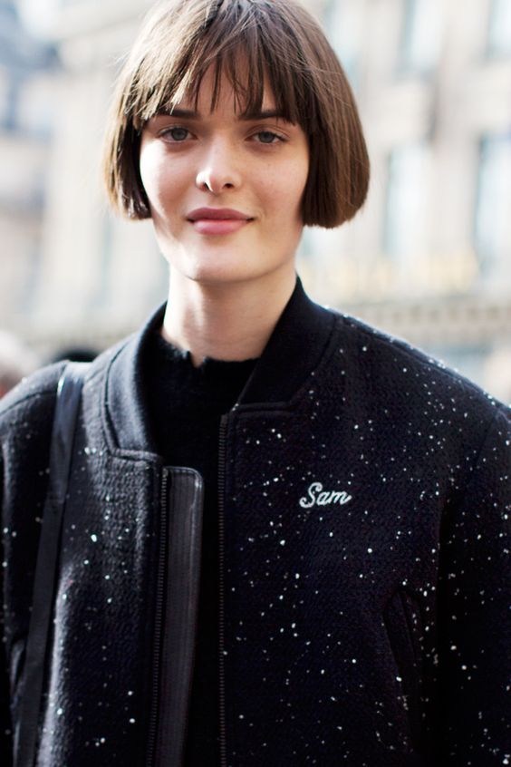 a classic ear length brunette bob with wispy bangs is a hairstyle loved by models