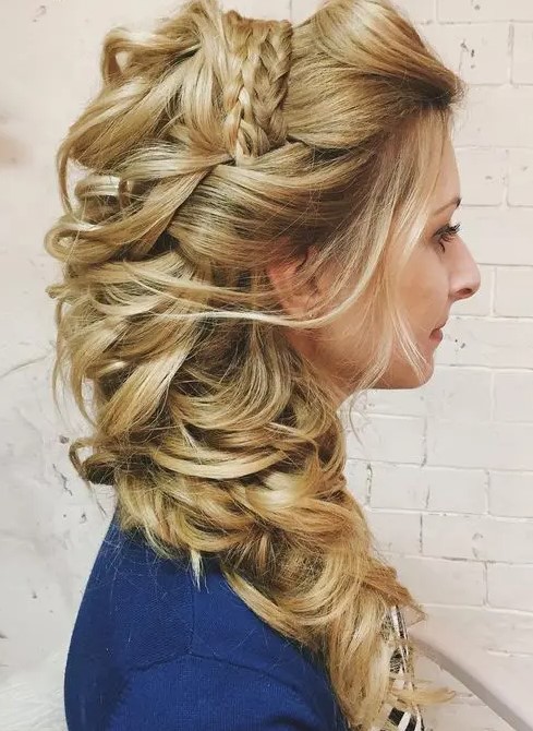 a complicated side swept hairstyle with waves and braids on top, with a huge loose wavy ponytail on one side