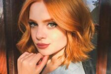 a cool copper red wavy long bob with face-framing layers looks really Instagram-worthy