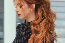 a cool low ponytail with a voluminous fishtail braid long the whole head and in the ponytail, with a messy volume on top