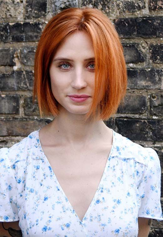 a copper red midi bob with volume and a sleek texture is a cool and chic idea for a bold look