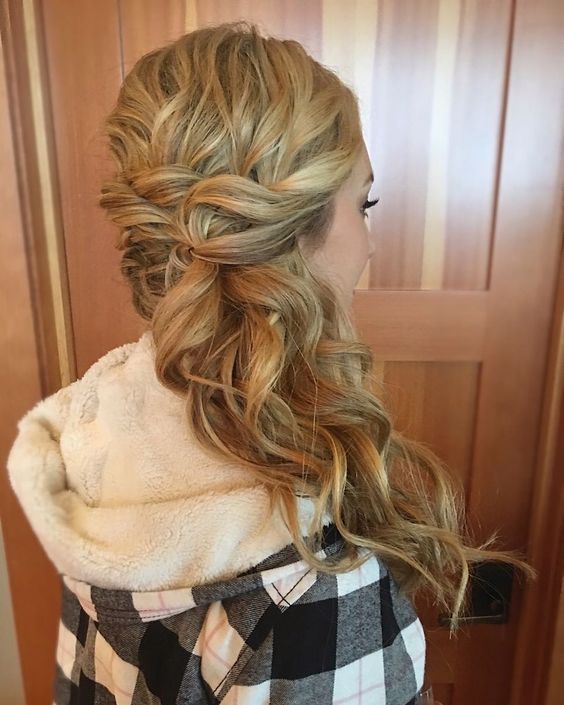 a curly side-swept half updo with a wavy top is a lovely idea for a bride, it looks pretty and chic