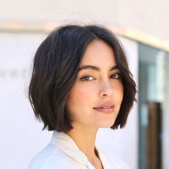 a cute and relaxed brunette midi bob with middle part and slight waves is a stylish idea if you love short length