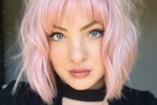 a cute light pink wavy long bob with wispy bangs and textured hair is a chic and pretty idea to rock