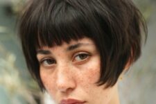 a dark brunette ear-length bob with a classic fringe and a messy volume is a cool solution and this hair is easy to style