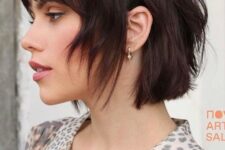 a dark chestnut shaggy and layered short bob with bottleneck bangs is a bold and catchy idea
