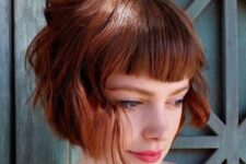 a deep red ear-length wavy bob with a classic fringe is a bold and cool idea, give it dimension