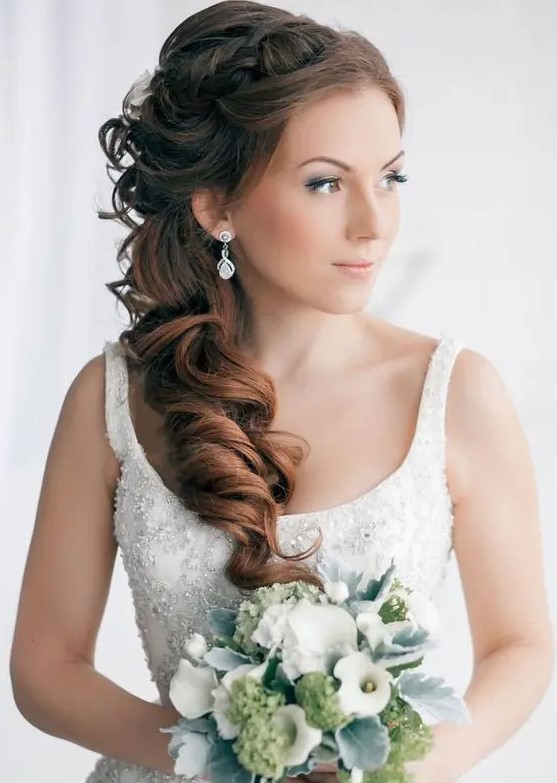 a delicate and chic side swept hairstyle with a twisted and dimension on top and waves down is a lovely and cool solution