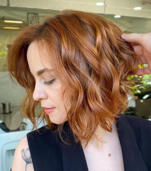 a delicate copper red wavy bob with volume is a cool and catchy idea if you don't want too bright colors