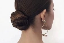 a formal wedding updo with a twisted low bun and a sleek top is a chic and beautiful idea that will fit any formal wedding