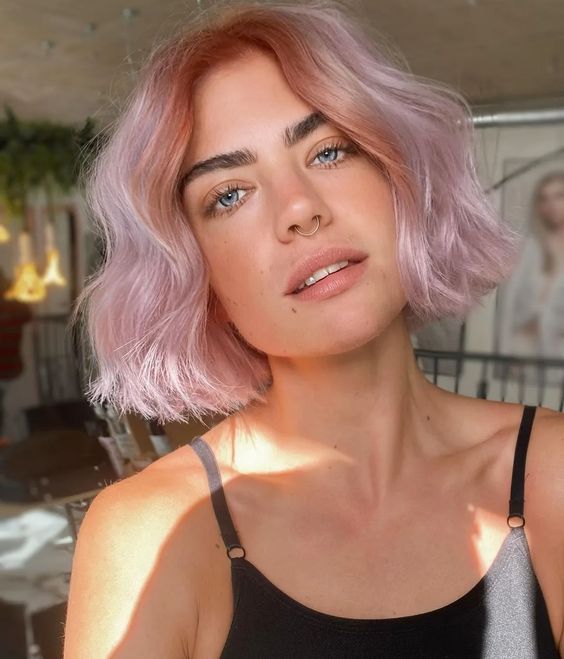 a girlish soft pink midi bob with a wavy volume is a cool and lovely idea to try