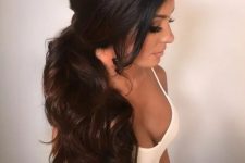 a gorgeous dimensional wavy side poyntail with a sleek volume on top is an amazing idea for a modern bride