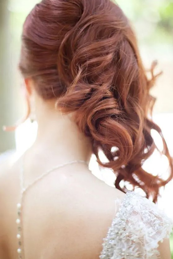 A gorgeous ginger side swept wavy hairstyle with face framing locks is a fantastic idea for a wedding