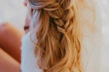 a half updo with a loose braid and waves down is a great romantic idea for a wedding guest or a bridesmaid