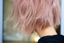 a jaw-line pink wavy and textured bob with a darker root is a cool and catchy idea