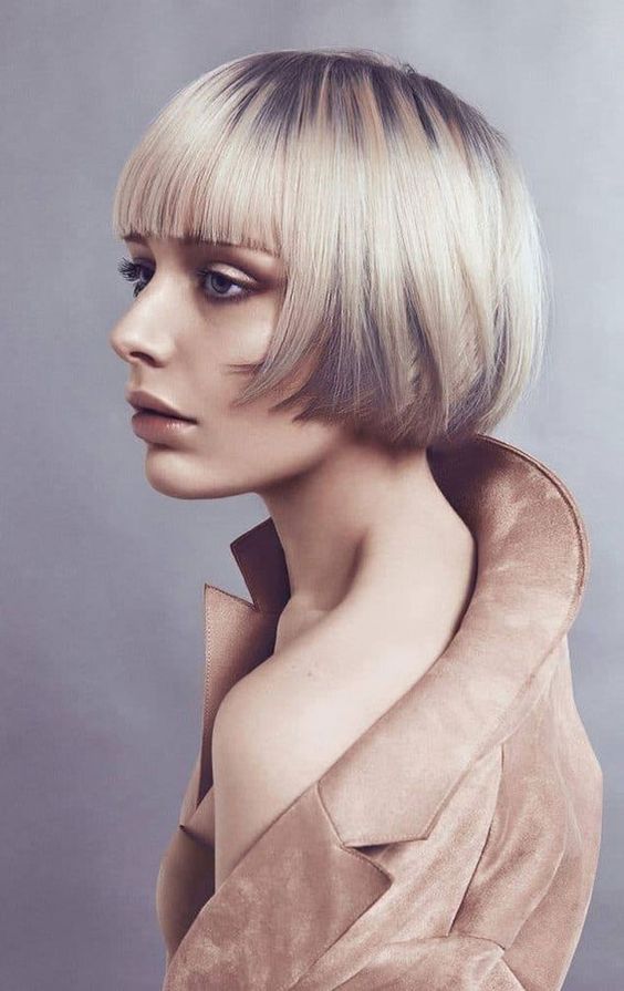 a layered ear length bob with graphite grey and platinum blonde, with a classic fringe will catch an eye with color contrast