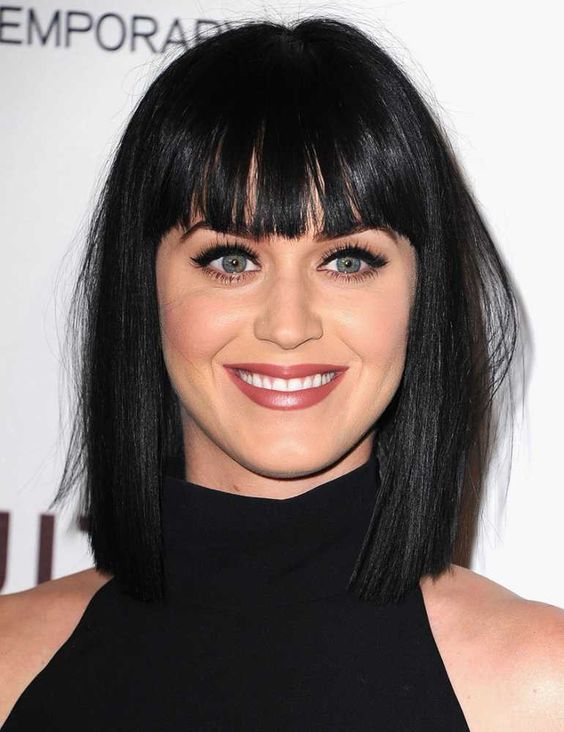 a long black shiny bob with a classic fringe is a stylish and catchy solution, it looks refined and cool