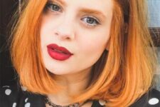a long ginger red bob with a lot of volume and curved ends is a cool and chic idea, a classic haircut with a bold color
