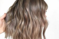 a long wavy bronde bob with a darker root is a stylish and catchy idea, and the soft shade will compliment many complexions