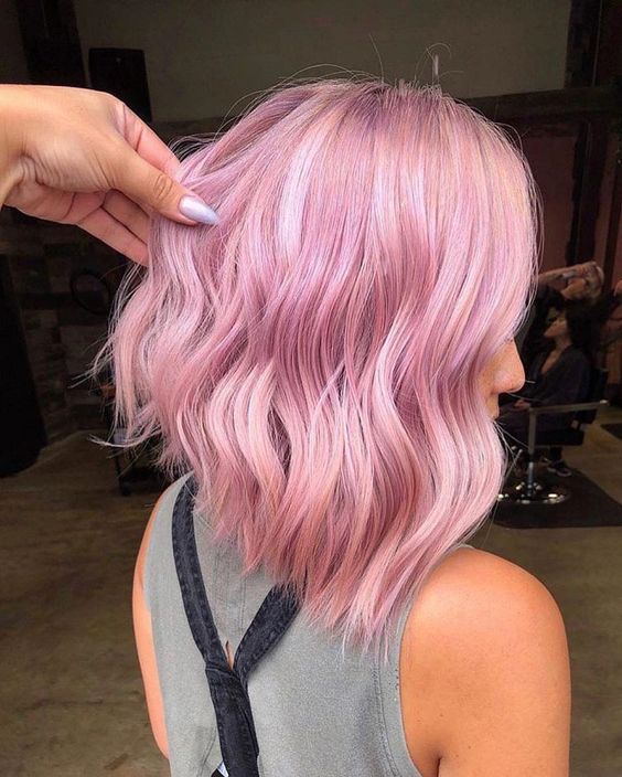 a lovely A-line wavy pink long bob will catch an eye both with the color and asymmetry