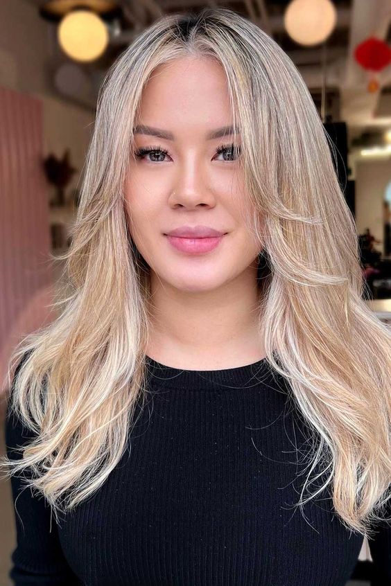 a lovely bleached blonde butterfly haircut with wavy ends and a bit of texture is a chic and catchy idea to rock