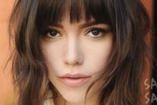 a lovely dark brown long shaggy bob with caramel highlights and a classic fringe plus messy waves is a cool and chic idea