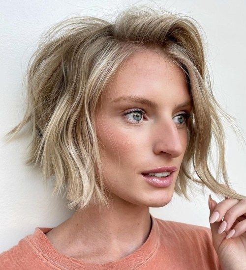 a lovely textured wavy chin length bob with a darker root is a cool and modern idea to try