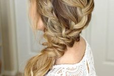 a low braided ponytail made up of several braids plus a halo is a relaxed idea for a rustic or boho wedding
