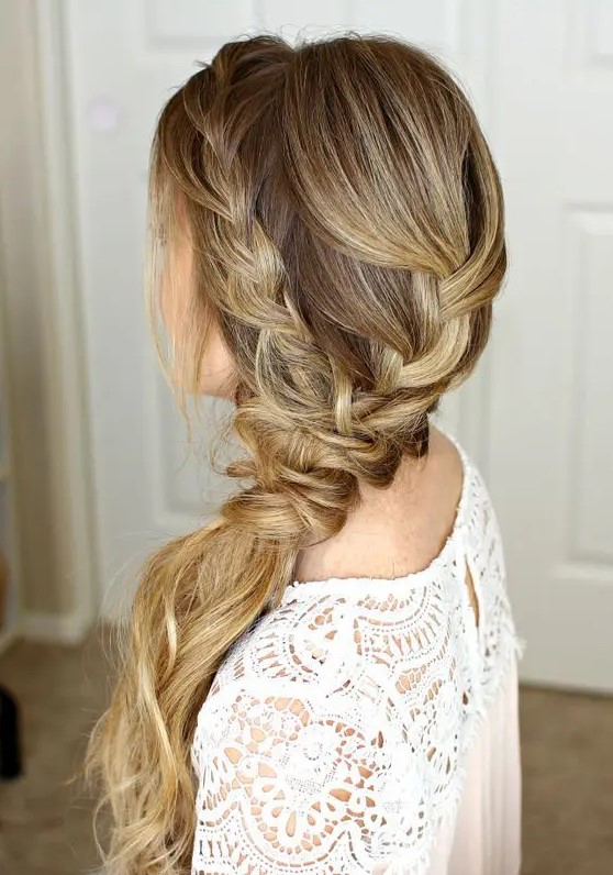 a low braided ponytail made up of several braids plus a halo is a relaxed idea for a rustic or boho wedding