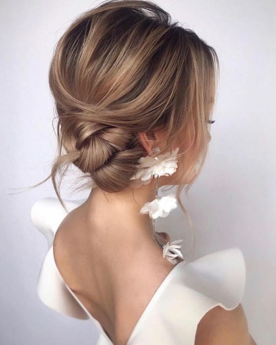 a low side bun with a bump on top is a cool idea for medium length hair, add face framing locks around