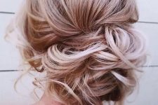 a messy curly low side bun with some curls down is a great idea for an effortlessly chic look