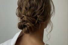 a messy elegant low bun with a wavy top and a wavy twisted bun, some locks down is a cool idea