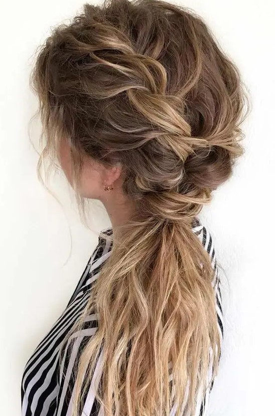 a messy side braid into a ponytail, with a messt braided top, some waves down is a lovely idea for a boho bride