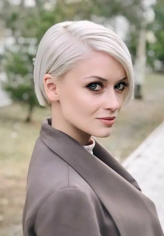 a minimalist platinum blonde ear length bob with side part and a sleek top is a classic idea that is always a perfect solution