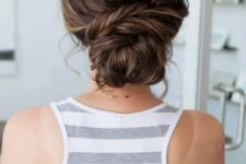 a pretty and a bit messy twisted low bun with a bump on top and some balayage is a chic and cool idea for a wedding