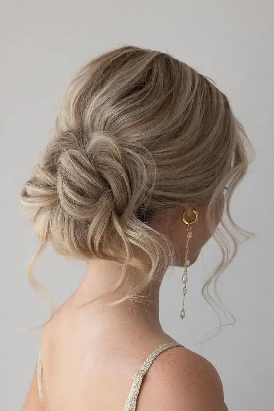 A pretty messy wavy low bun with a bit of volume on top, some locks down and face framing hair