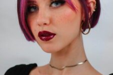 a purple ear-length bob with a hot pink money piece is a fantastic statement with color