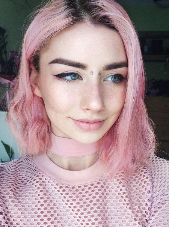 a relaxed pink long bob with a darker root and messy waves is a cute hairstyle