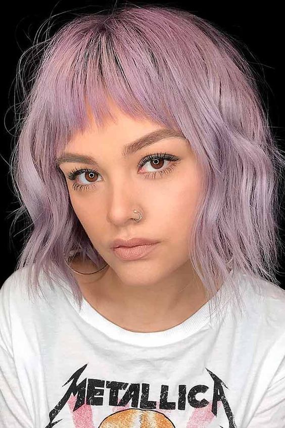 a shaggy lilac long bob with wispy bangs that accent the eyes, with a bit of volume and texture