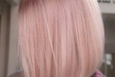 a shiny light pink bob with central parting and straight hair is fantastic for anyone who loves such shades