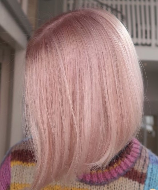 a shiny light pink bob with central parting and straight hair is fantastic for anyone who loves such shades