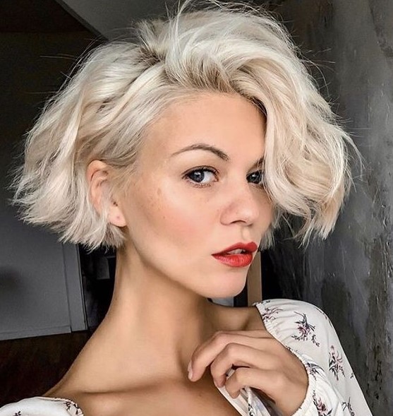 a short bleached ear-length bob with a lot of volume and waves looks very chic and lovely