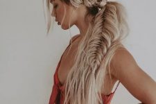 a side swept hairstyle of a dimensional and loose fishtail braid and some waves down and some locks down is wow