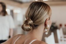 a sleek and knotted low bun with a sleek top will fit a modern, minimalist or just formal bridal look