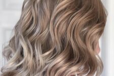 a soft and subtle bronde long bob with waves and volume is a catchy and chic solution