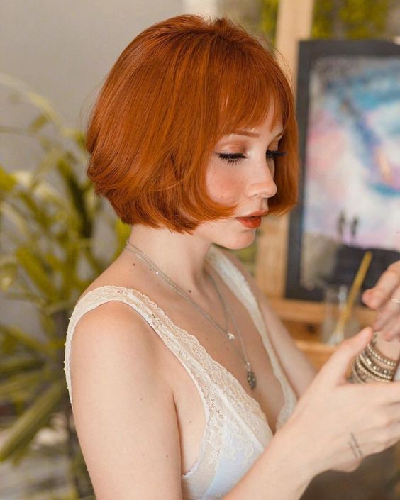 a stunning ginger red chin length bob with a bit of layers and wispy bangs is a lovely idea that looks a bit retro
