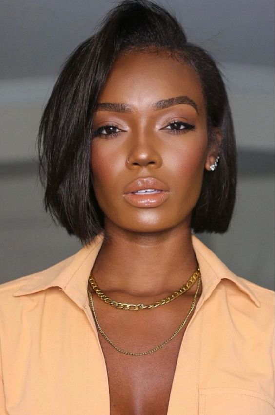 a stylish and catchy shiny black midi bob with side part and a lot of volume looks incredibly chic and bold