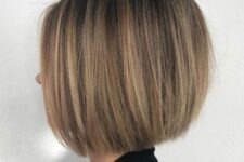 a stylish midi bronde bob with highlights and a darker root, with balayage is a chic and elegant idea for a bold look