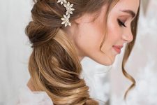 a stylish twisted curly side ponytail with a vump on top and an embellished hair combo is a chic and refined idea